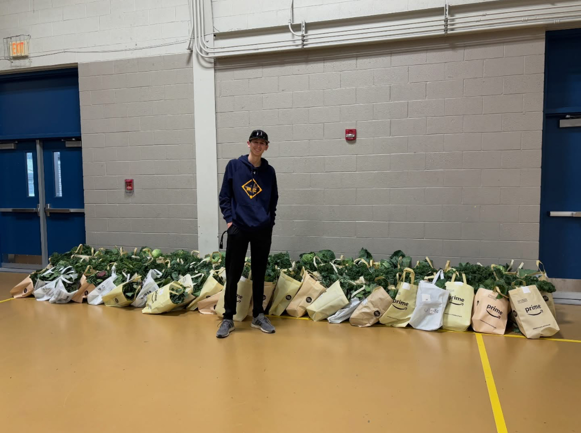 Baseball's Seth Suppi stands amongst the produce donations from Bottino's Shop Rite